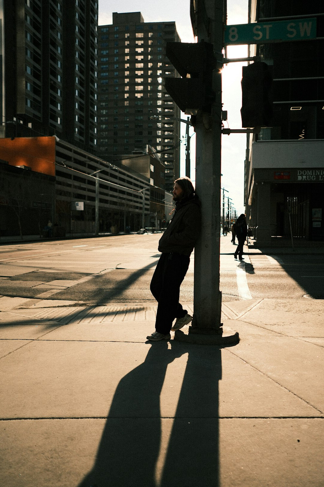 Street photographer holding a camera on a city sidewalk