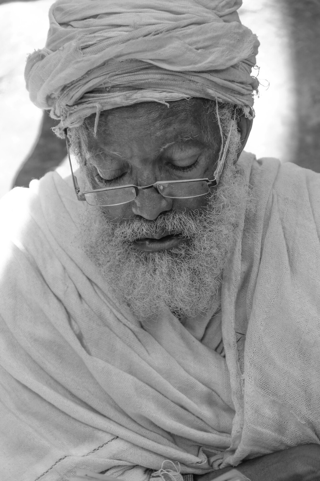 Portrait of a man with a beard and glasses